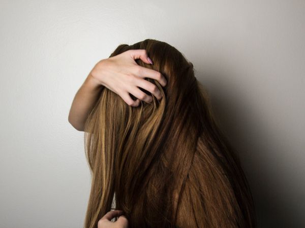 photo of woman covering face with her hair