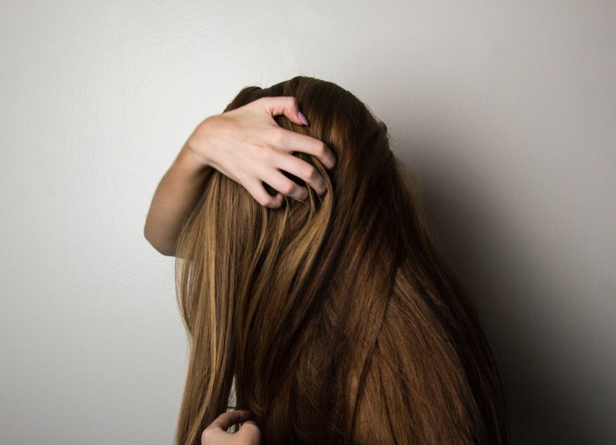 photo of woman covering face with her hair