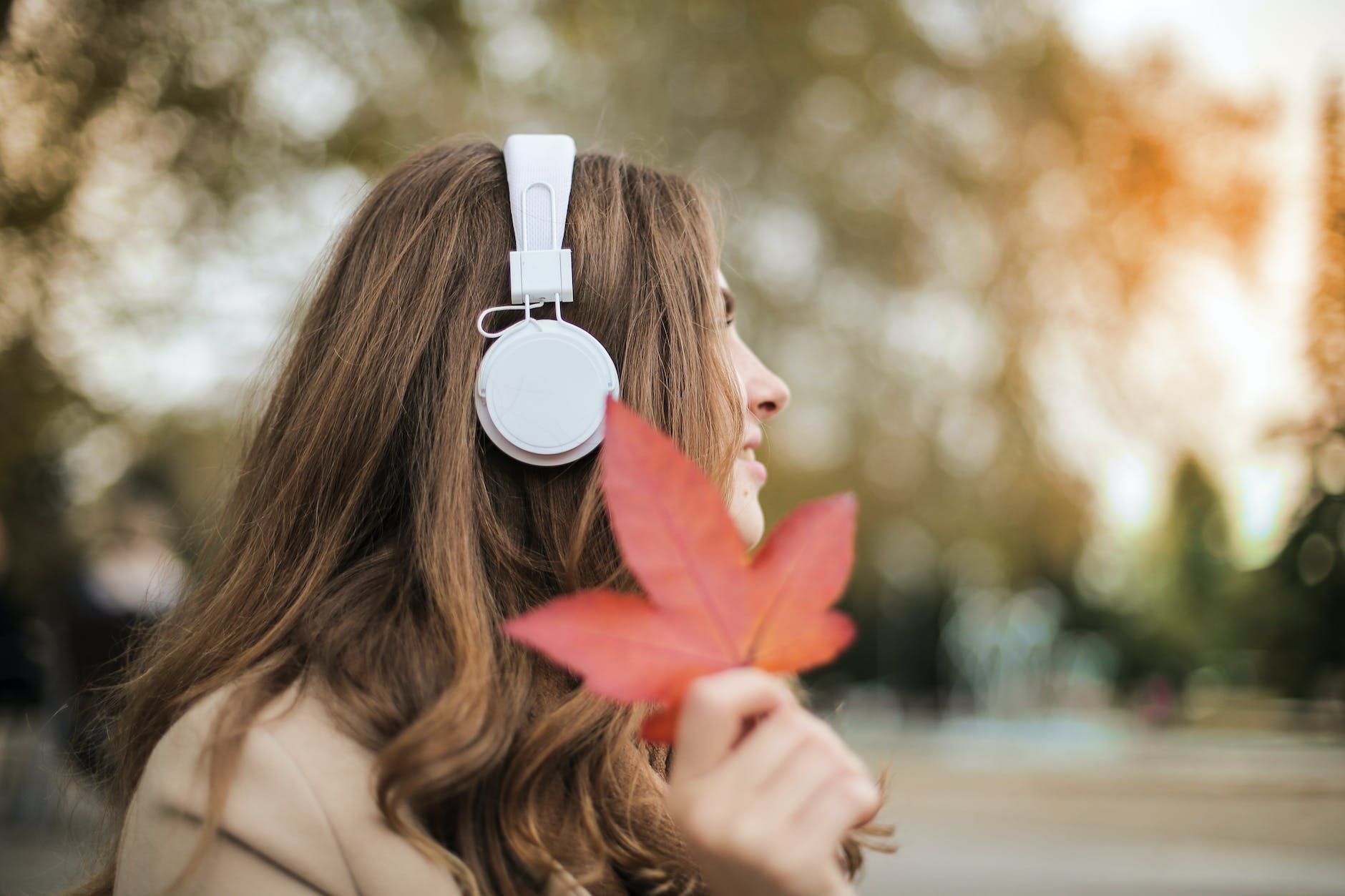 photo of woman wearing white headset