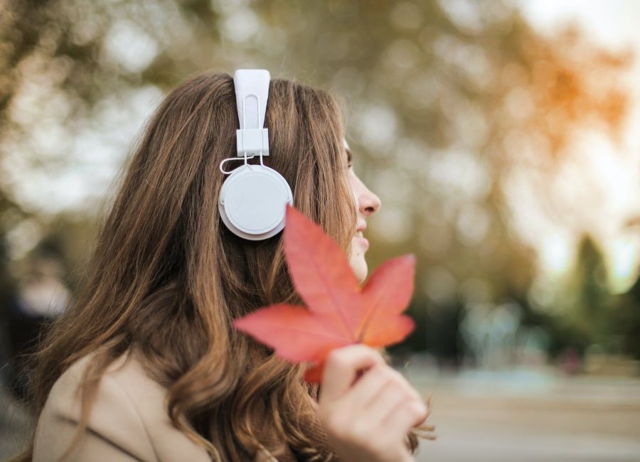 photo of woman wearing white headset